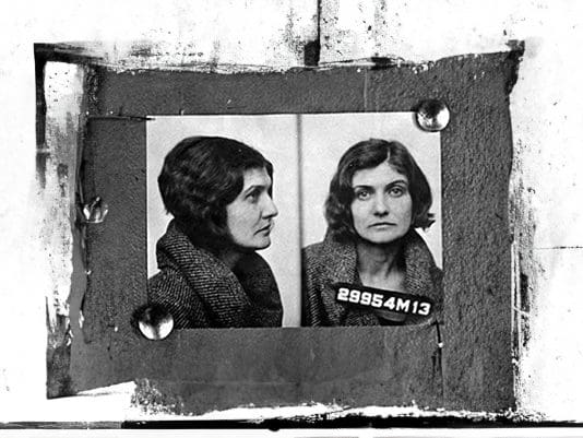 A black and white photo of two women in jail.