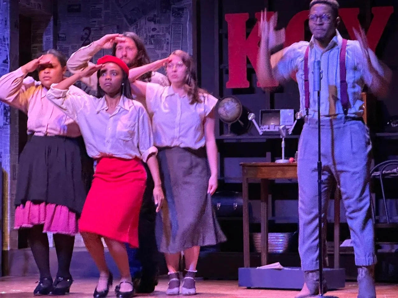 A group of people standing on top of a stage.