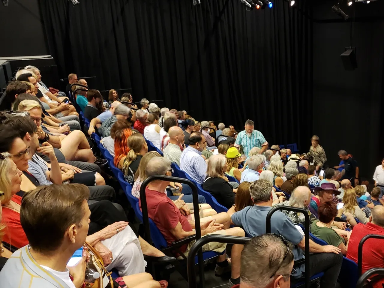 A large group of people sitting in rows.